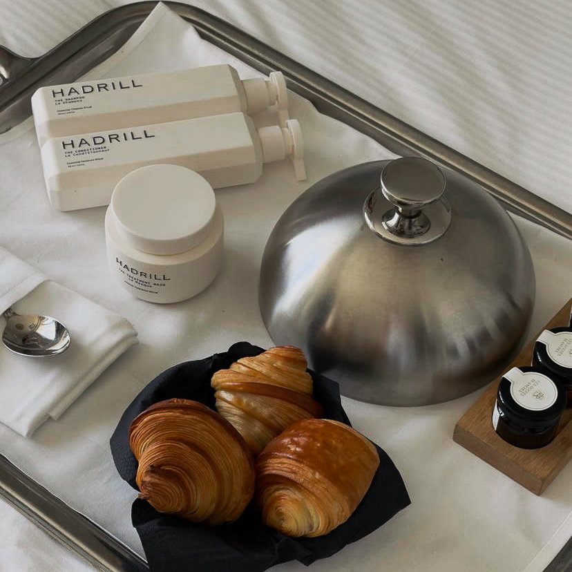 Hadrill Shampoo, Conditioner and Treatment Mask beside breakfast